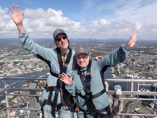 fiona and paul at skypoint climb peak with view of gold coast in background