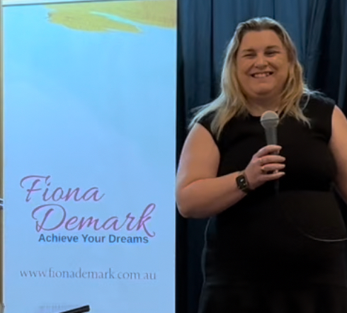 fiona demark presenting with microphone
