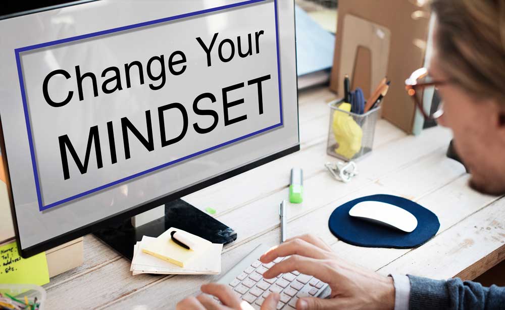 image of computer screen with the sign 'Change your Mindset' on it to demonstrate toxic positivity