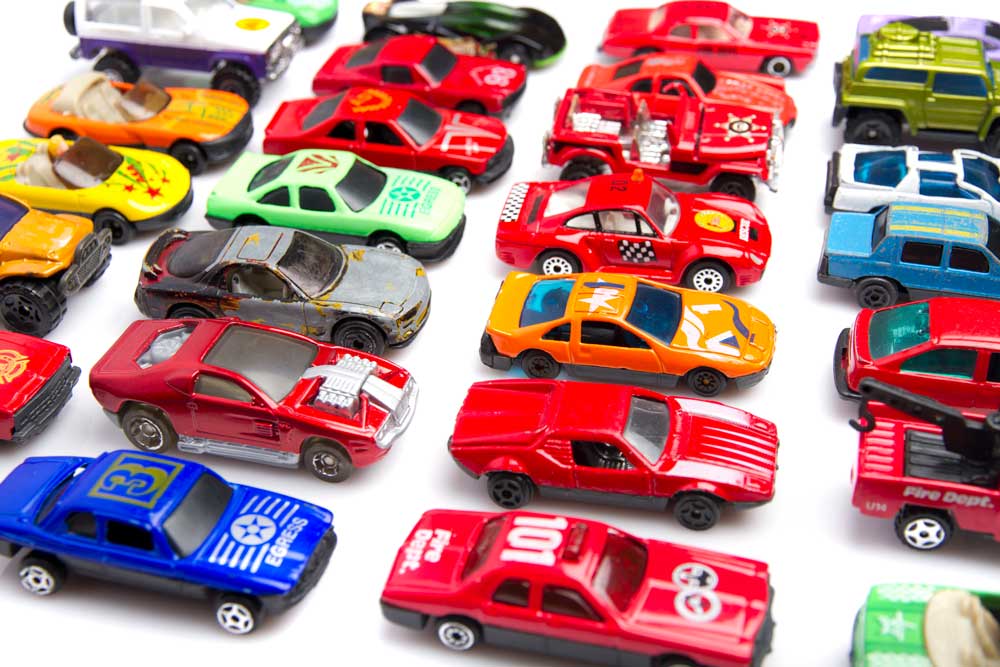 toy cars, predominantly red, lined up in rows to demonstrate Reticular Activating System.
