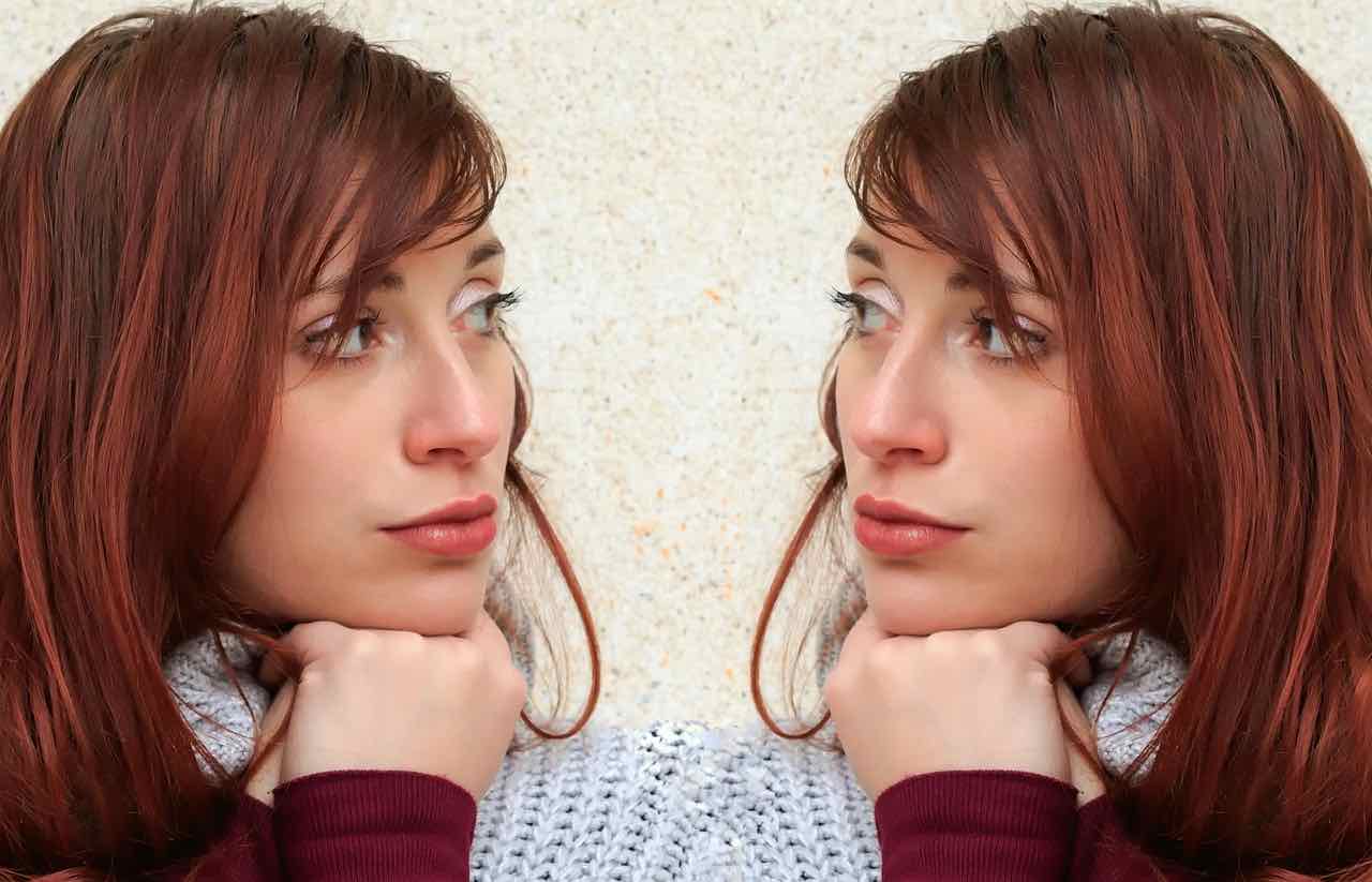 woman looking to her side at herself