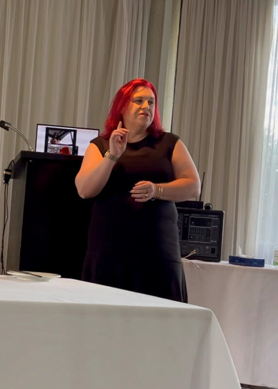 fiona demark keynote speaker for corporate events speaking and gesturing with her hand